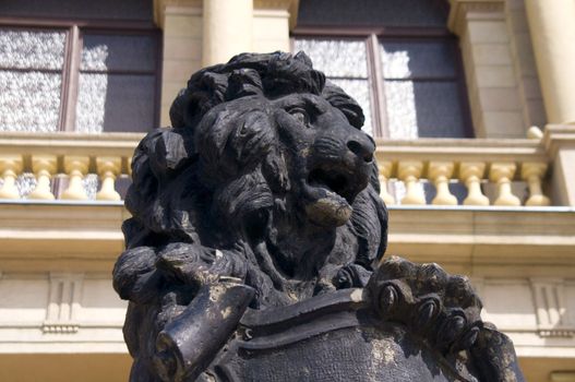 Facade of a city building. City street. Statue of a lion.