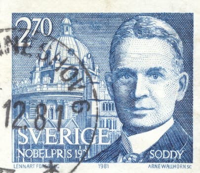 The scanned stamp. Portrait of the young man. Architectural construction.