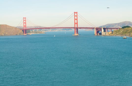 Airship or blimp cruising over San Francisco and the Golden Gate Bridge