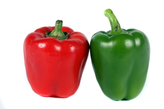 A pair of red and green capsica, on white studio background.