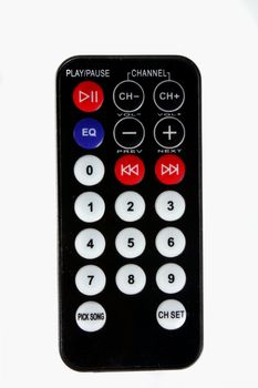 A black remote control of a music system, isolated on white background.
