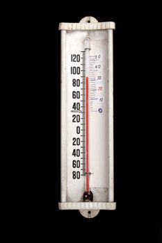 An old mercury thermometer, isolated on black studio background.