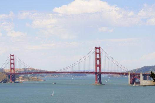 Golden gate bridge from the Presidio, with sail boats and a cruise ship in the bay