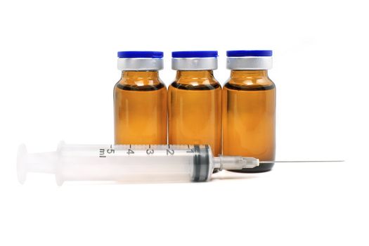 Syringe, glass bottles with drugs isolated on white