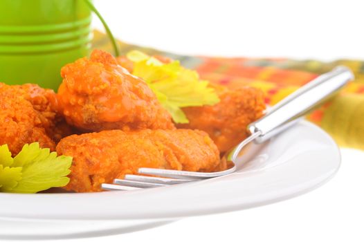 Closeup of a plate of spicy buffalo style chicken wings.