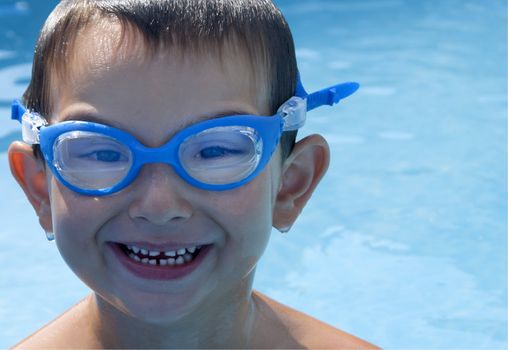 A kid came out from Swimming pool with his goggles half full.