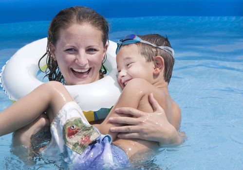 Mother and son having good time in the swimming pool.