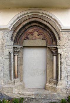 Image of the ancient roman arch - portal of the church of St. Peter and Paul, Podivin, Moravia, Czech republic.