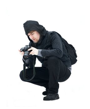 Crouching photographer isolated on white background