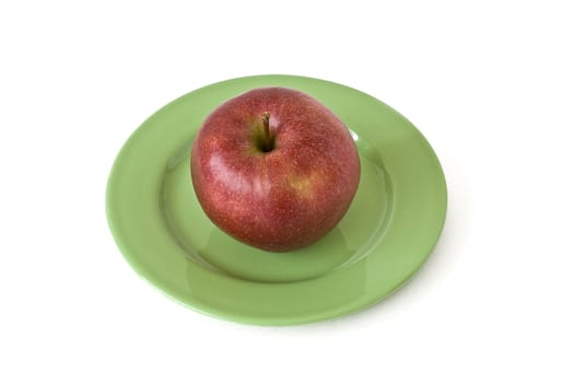 red apple on a green plate on a white background