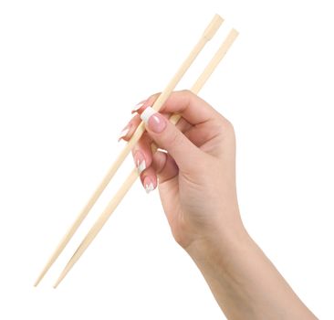 Female hand holding Chinese chopsticks against white background.