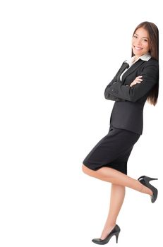 Businesswoman in suit leaning on wall. Young Caucasian Asian professional woman isolated on white background