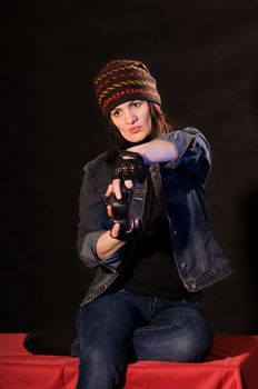 woman gamer with joystick  on darken background