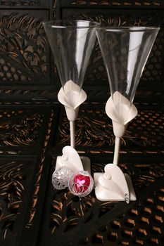 Decorated long stem glasses with a chocolate heart and rings