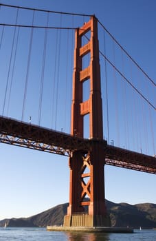 Golden gate bridge from underneath, with sail boats in the bay