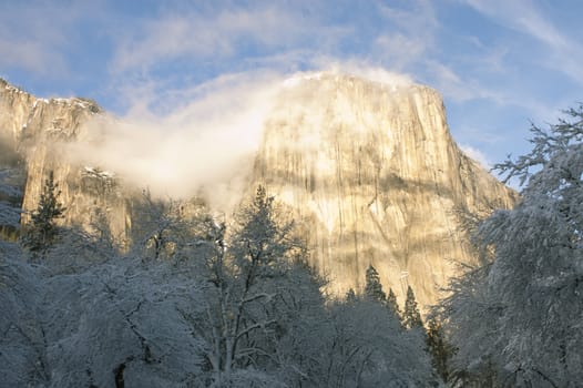 El Capitan with small whispy clouds in the winter at sunset