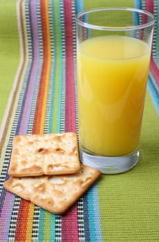 Glass of Orange Juice and two crackers