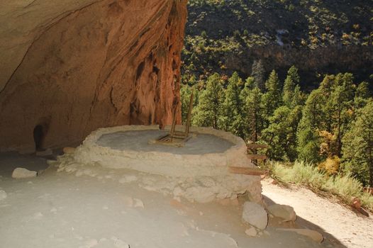 reconstructed ancient Anasazsi (Puebloan) indian dwelling at Bandelier in New Mexico, with ladder going down to the entrance of the Kiva