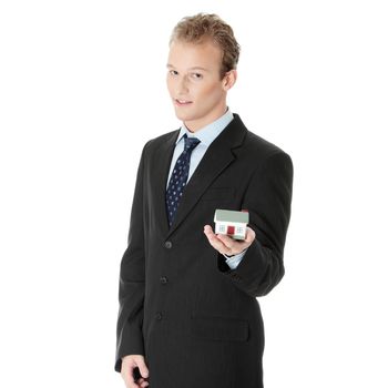 Young business man with house model on hand- real estate concept. Isolated on white