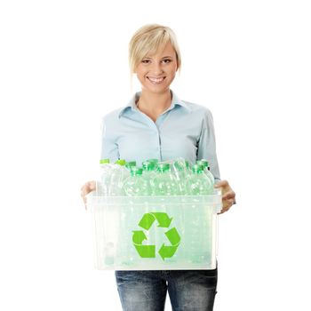 Young woman carrying a plastic container full with empty recyclable household material. Recycling concept