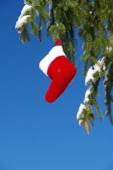 Santa Claus Christmas boot for gifts outside in a snowy landscape