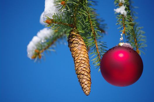 red bauble christmas ball ornament outside in a snowy winter scene