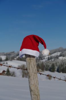 red santa claus hats in a snowy landscape