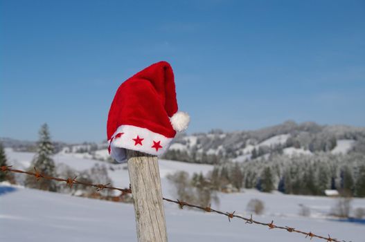 red santa claus hats in a snowy landscape