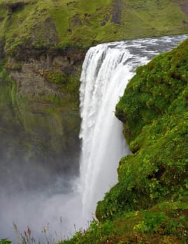 Waterfall in green environment on a mountain in iceland