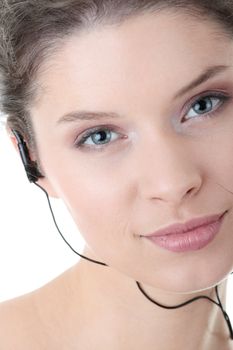 Young fitness woman with sport headphones listening music isolated