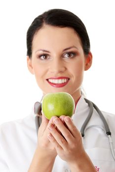 Healthy eating or lifestyle concept. Smiling woman doctor with a green apple.