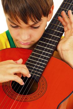 caucasian boy portrait with orange wooden guitar