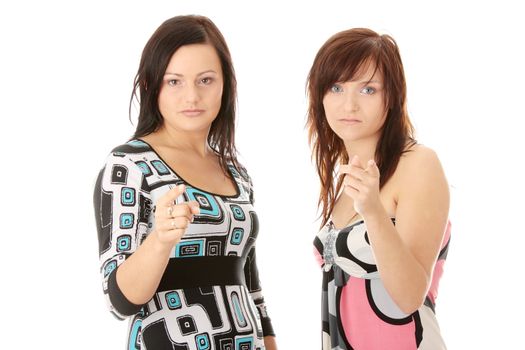 Two young womans pointing, isolated on white background