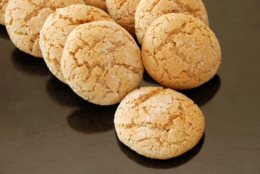 fresh appetizing oatmeal cookies on black oven pan