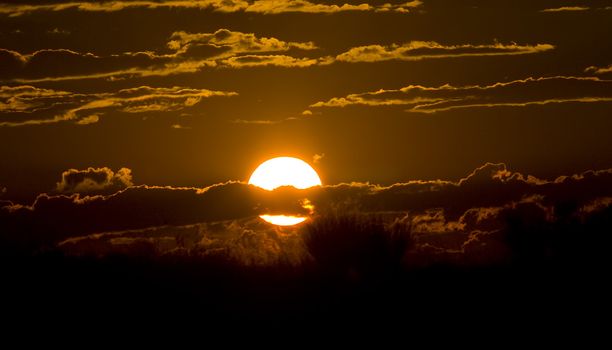 The blazing sun setting at the end of an african day