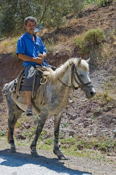 A villager riding his horse to his village from town ( 15 km ride)