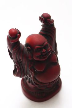isolated shot of red buddha statue on white background