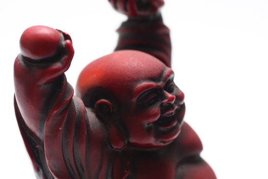 isolated shot of red buddha statue on white background