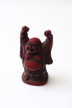 isolated shot of red buddha statue on white background