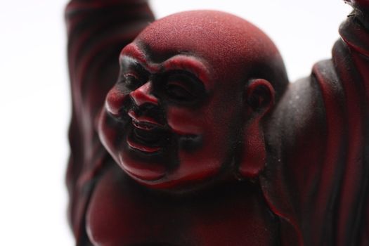 isolated shot of red buddha statue on white background