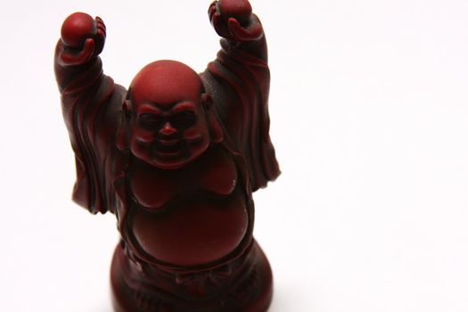 isolated shot of red buddha statue on white background