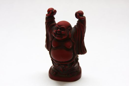 isolated shot of red buddha statue on white background