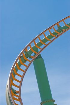 Rollercoaster track against a brilliant blue sky