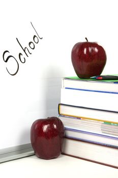 White board, apples and books in a classroom