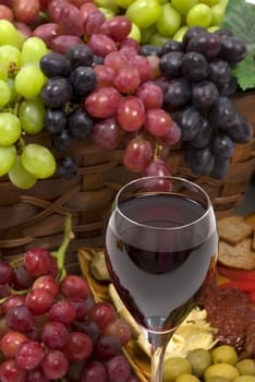 Three different kinds of seedless grapes and wine