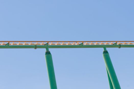 Rollercoaster track against a brilliant blue sky