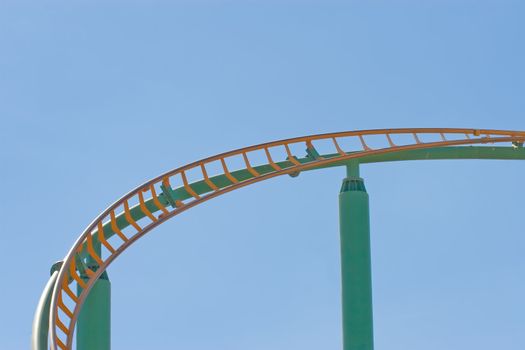 Rollercoaster track against a brilliant blue sky