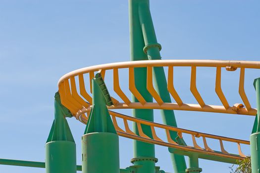 Rollercoaster track against a brilliant blue sky