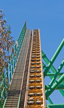 Rollercoaster track against a brilliant blue sky