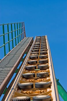 Rollercoaster track against a brilliant blue sky